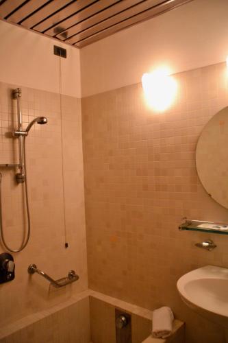a bathroom with a shower and a toilet and a sink at Hotel Italia in Foligno