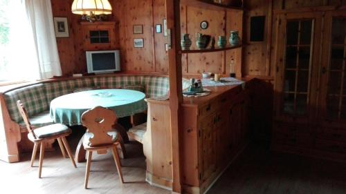 a kitchen with a table and a chair in a room at Ferienhaus Roman in Hinterstoder