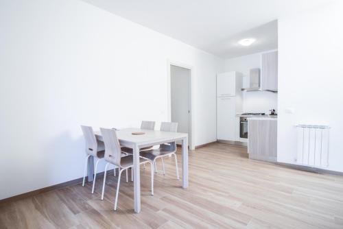 a white dining room with a white table and chairs at Santa Caterina in Levanto