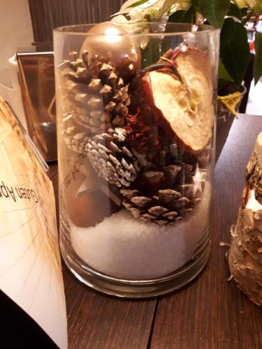 a glass jar filled with pine cones and snow at Gasthof zum Rassen in Garmisch-Partenkirchen