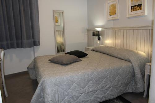 a bedroom with a bed with two pillows on it at Bed & Breakfasts Conte Perollo in Sciacca