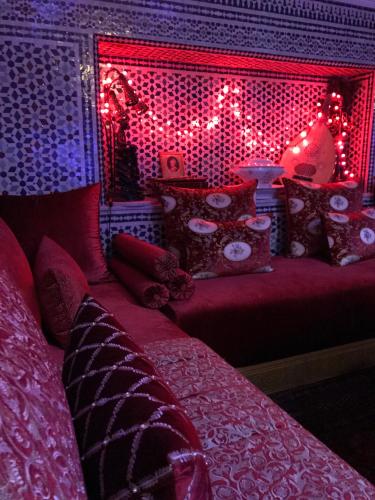 a bedroom with a bed with christmas lights on it at Riad Amor - Suite & Spa in Fès