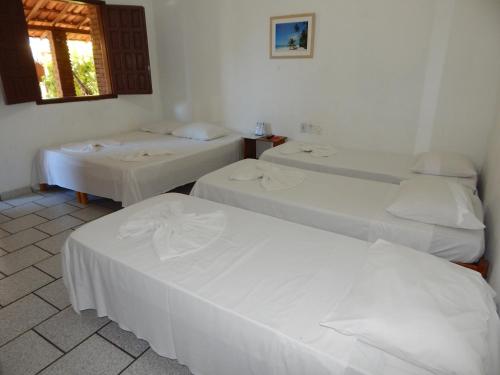 Una cama o camas en una habitación de Pousada Água de Côco