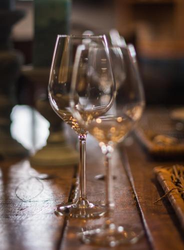two glasses of white wine sitting on a wooden table at Hof ter Sysen in Loppem