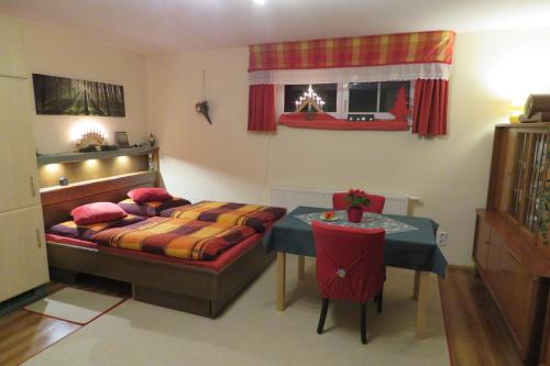 a bedroom with a bed and a table in it at Stollenklause in Hormersdorf
