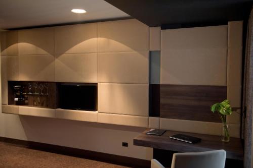 a kitchen with a table and a microwave at Kronwell Brasov Hotel in Braşov