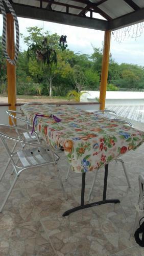 a table and a chair with a blanket on it at Casa de Campo Palmarito in Tubará