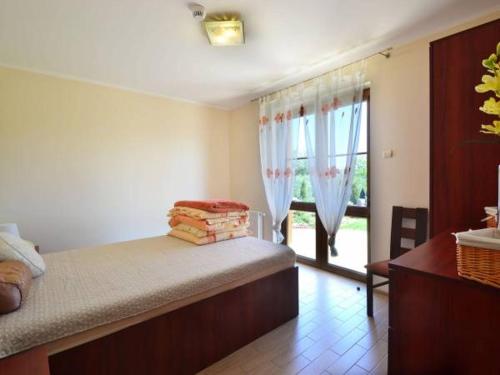 a bedroom with a bed and a window and a table at Villa Marcus in Rowy