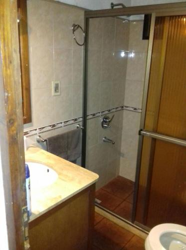 a bathroom with a shower and a sink at las cuatro eme in Paysandú
