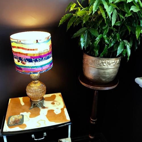 a lamp on a table next to a potted plant at Vine Valley Inn in Cessnock