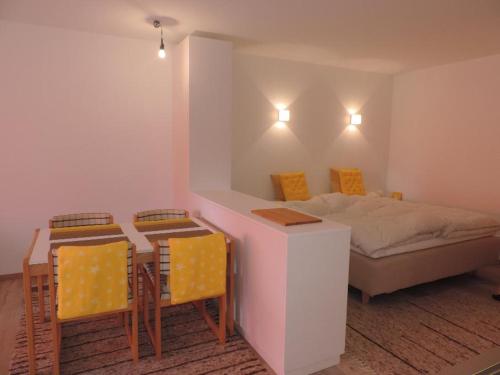 a bedroom with a bed and a table and chairs at Damiez (171 Zi) in Lenzerheide