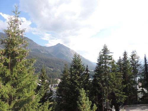 a group of trees with mountains in the background at Montalin (451 Ti) 1. Stock in Valbella