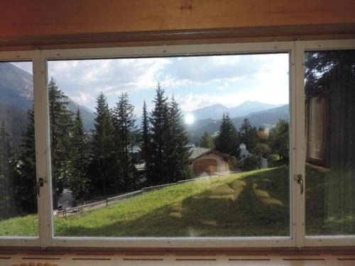 a window with a view of a mountain view at Montalin (451 Ti) 1. Stock in Valbella