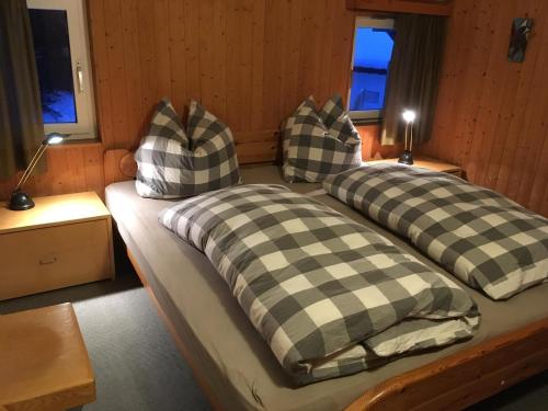 a bed with two pillows on it in a room at Las Bargias 12 (407 Ho) in Lenzerheide