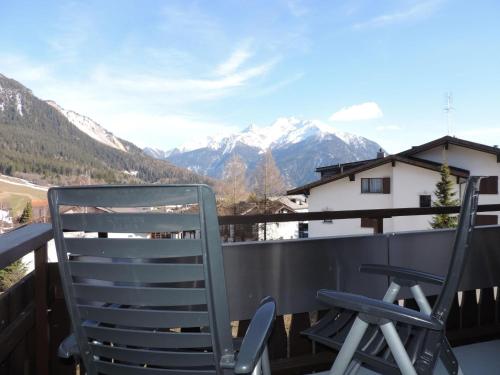 a pair of chairs on a balcony with mountains at Barhetta (389 Ma) in Lenz