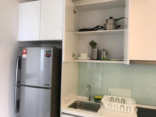 a kitchen with a refrigerator and a sink at CBD3 SOHO in Cyberjaya