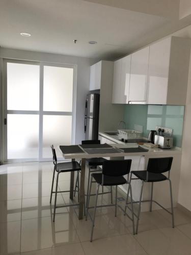 a kitchen with a table and chairs in a room at CBD3 SOHO in Cyberjaya