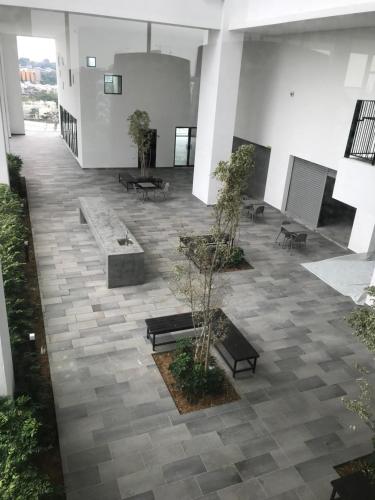 a courtyard with benches and trees in a building at CBD3 SOHO in Cyberjaya