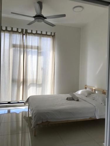 a bedroom with a bed with a ceiling fan at CBD3 SOHO in Cyberjaya