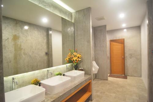 a bathroom with two sinks and a large mirror at Lanta Hostel in Ko Lanta