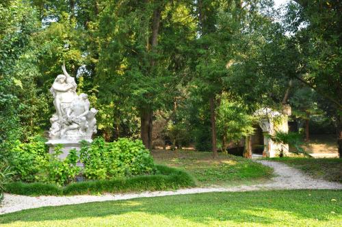 a statue sitting in the middle of a park at Hotel Villa Condulmer in Mogliano Veneto