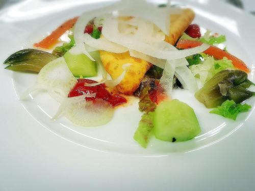 a white plate of food with vegetables on it at Hotel Antines in La Villa