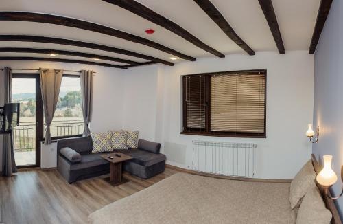 a living room with a couch and a table at Vila Lidia in Tsigov Chark