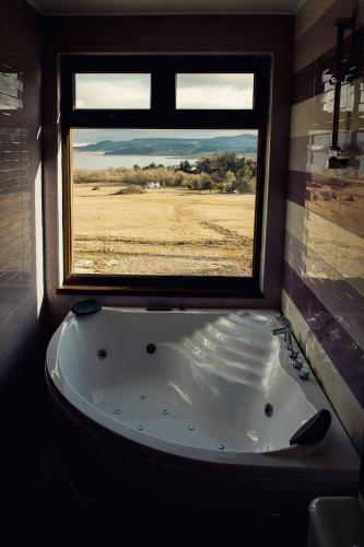 a bath tub in a room with a window at Vila Lidia in Tsigov Chark