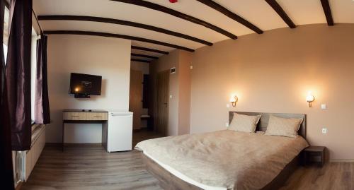 a bedroom with a large bed in a room at Vila Lidia in Tsigov Chark