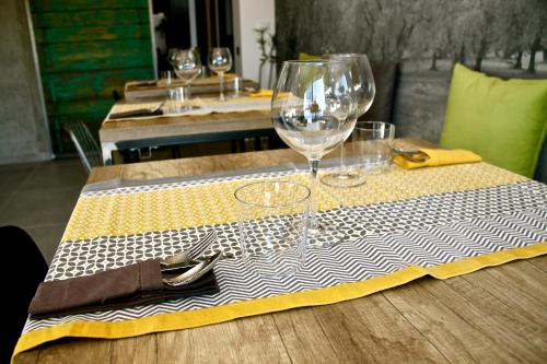 a table with a table cloth with wine glasses on it at Pove 2.4 Hotel in Pove del Grappa