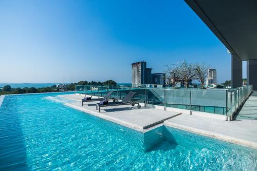 a swimming pool on the roof of a building at Arize Hotel Sri Racha in Si Racha