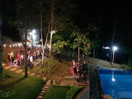 a group of people in a park at night at Grace Hill Villa Lubuk Minturun in Padang