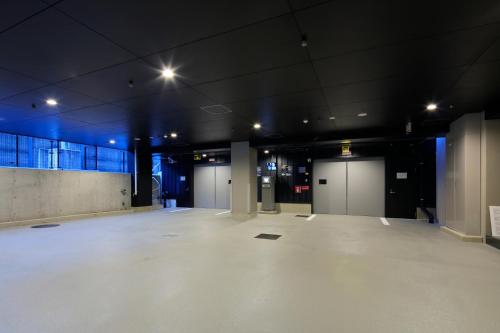 a large empty room with doors in a building at THE SINGULARI HOTEL & SKYSPA at UNIVERSAL STUDIOS JAPAN in Osaka