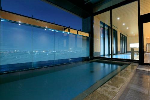 a swimming pool in the middle of a house at THE SINGULARI HOTEL & SKYSPA at UNIVERSAL STUDIOS JAPAN in Osaka