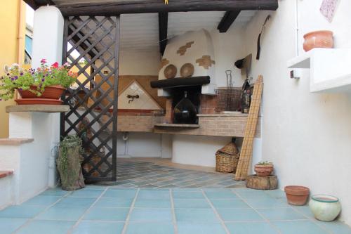an outdoor kitchen with a shelf and a stove at B&B S'arenada in Ghilarza