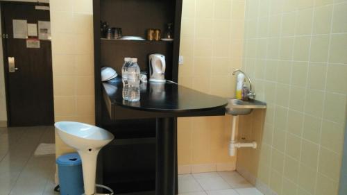 a bathroom with a sink and a toilet at Richone Maluri Private Hotel in Kuala Lumpur