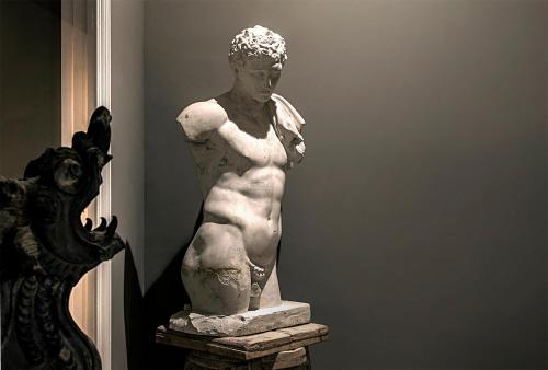 a statue of a nude man in a room at Seven Rooms Villadorata in Noto