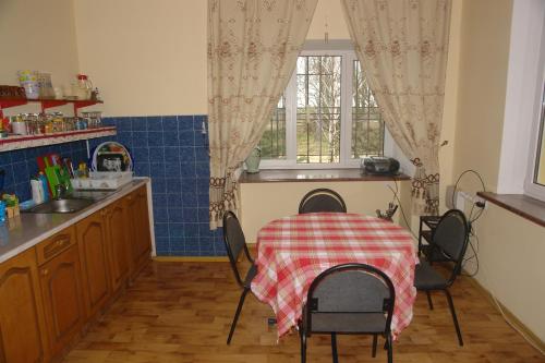 a kitchen with a table with a table cloth on it at Dacha u Morya Bugaz in Gribovka