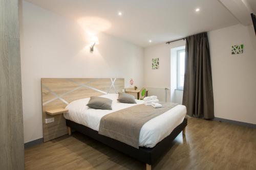 Ένα ή περισσότερα κρεβάτια σε δωμάτιο στο Le Relais Délys
