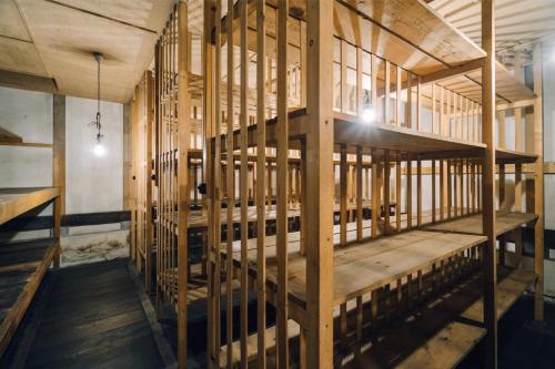 a room with a wooden staircase in a building at Otarunishikien in Otaru
