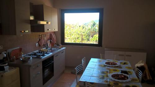 a kitchen with a table with two plates on it at La Casa Dei Colori in Zafferana Etnea