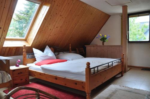 オストゼーバート・ニーンハーゲンにあるSommerferienhausのベッドルーム1室(大型木製ベッド1台、枕付)