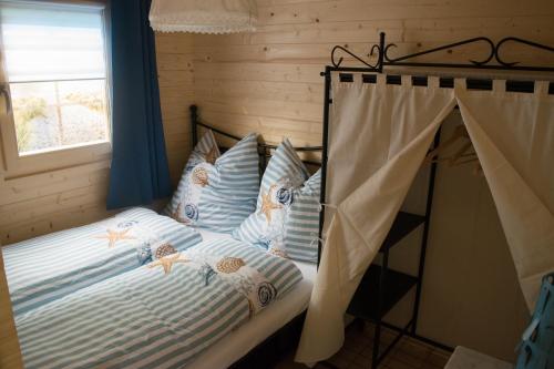 a bedroom with a bed with blue walls and a window at Glantalhütte in Glan-Münchweiler