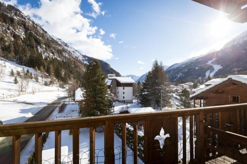 a view of a snowy mountain from a balcony at Hotel Lyshaus in Gressoney-Saint-Jean