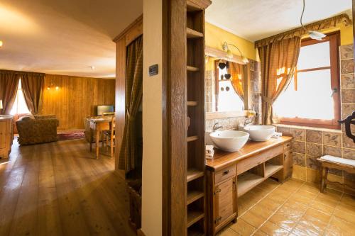a bathroom with two sinks on a wooden counter at Hotel Lyshaus in Gressoney-Saint-Jean