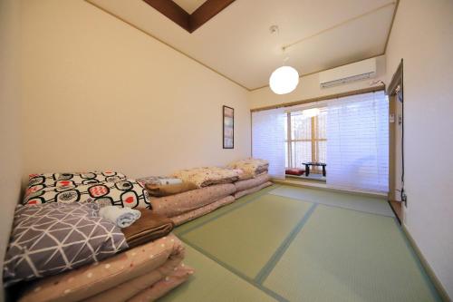 a living room with a couch and a window at Oyado Tofukuji 2 in Kyoto