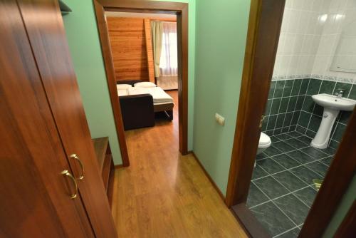 a bathroom with a toilet and a sink in a room at Motel Karpaty in Mohnate