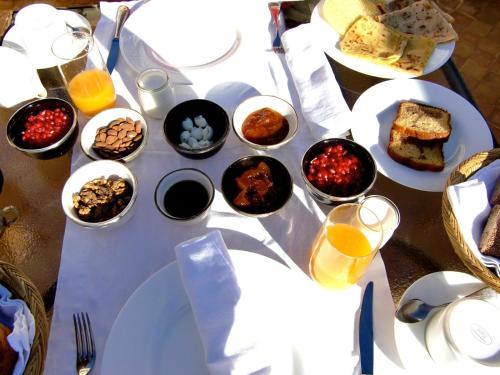 a table with plates of food and glasses of orange juice at Riad Joya in Marrakesh