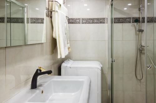 a bathroom with a shower and a sink and a toilet at Milano Suite in Lev Eilat in Eilat