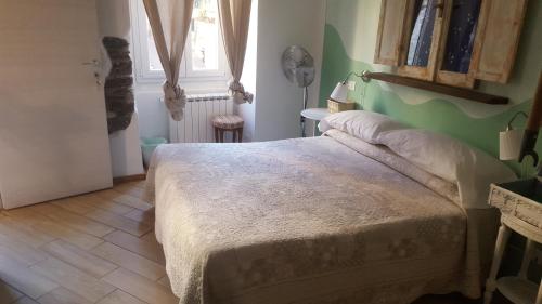a bedroom with a bed and a dresser at La Gioia in Camogli